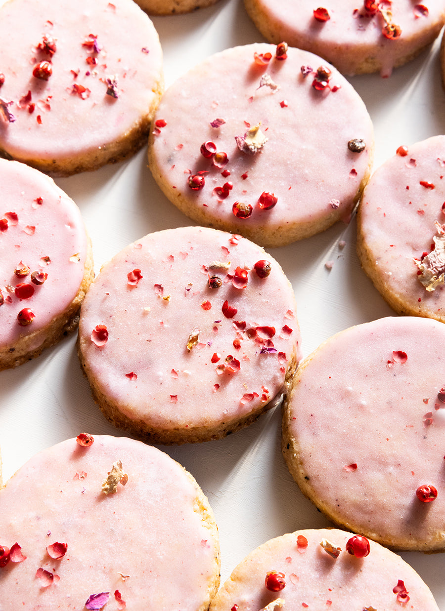 Pink frosted shortbread cookies made with Fleur Spice and Baies Rose.