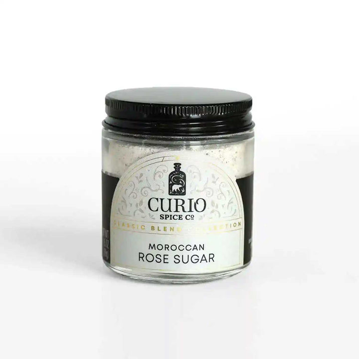 A glass jar of Moroccan Rose Sugar, a blend of fair trade cane sugar and Moroccan Damask rose petals.