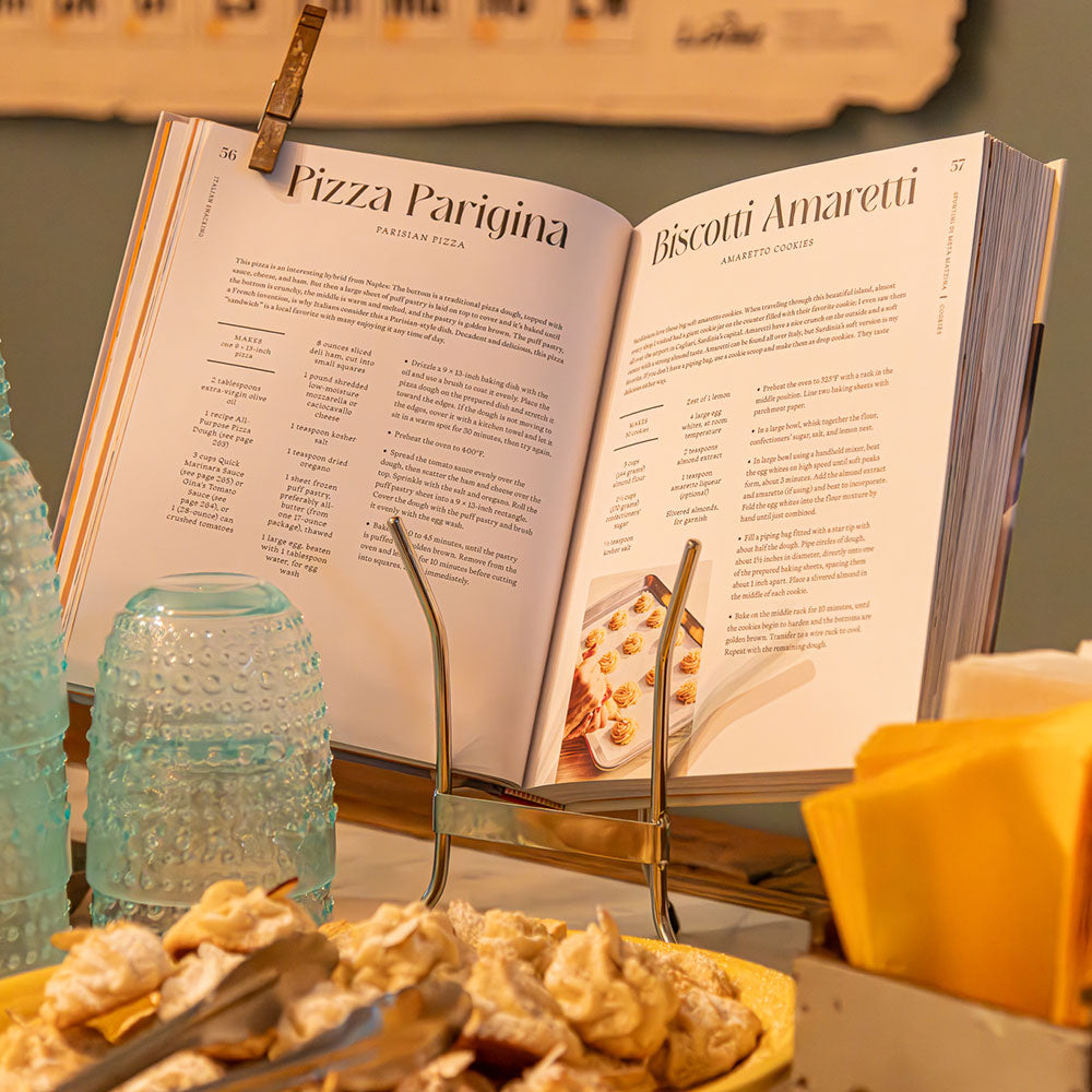 Anna Gass' cookbook "Italian Snacking" next to an array of snacks and drinks from her cookbook