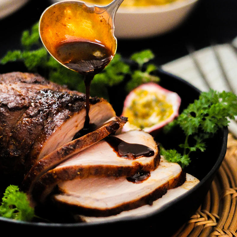 Photo of a pork roast with a spiced fruit sauce