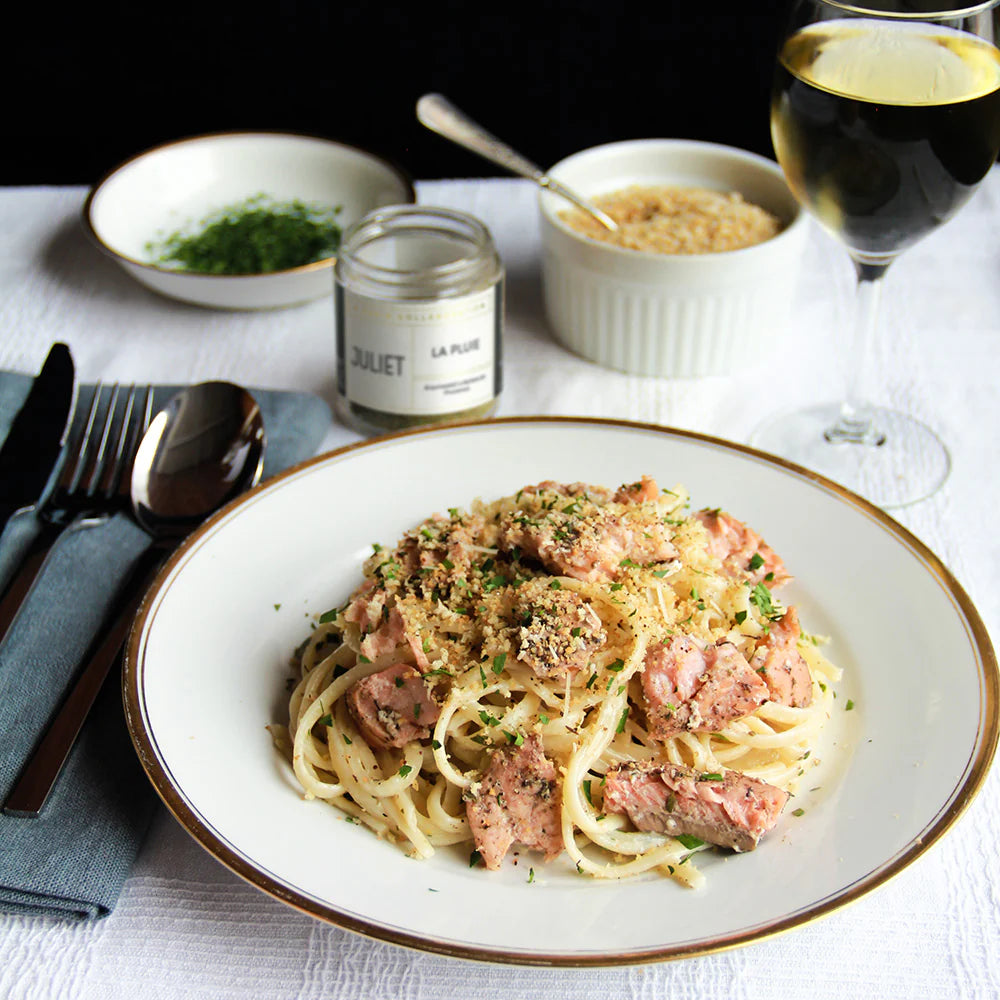Photo of a plate of salmon and pasta in cream sauce