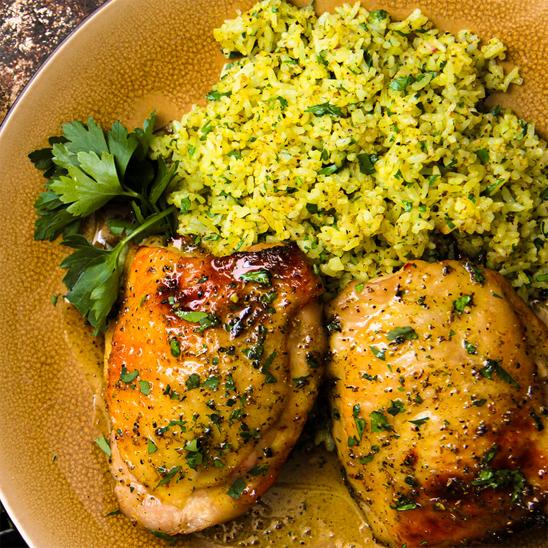 Photo of a plate of chicken thighs and rice