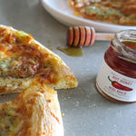 African Bronze Hot Honey poured over pizza.