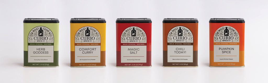 Five labeled containers of 'Curio' spices on a white background