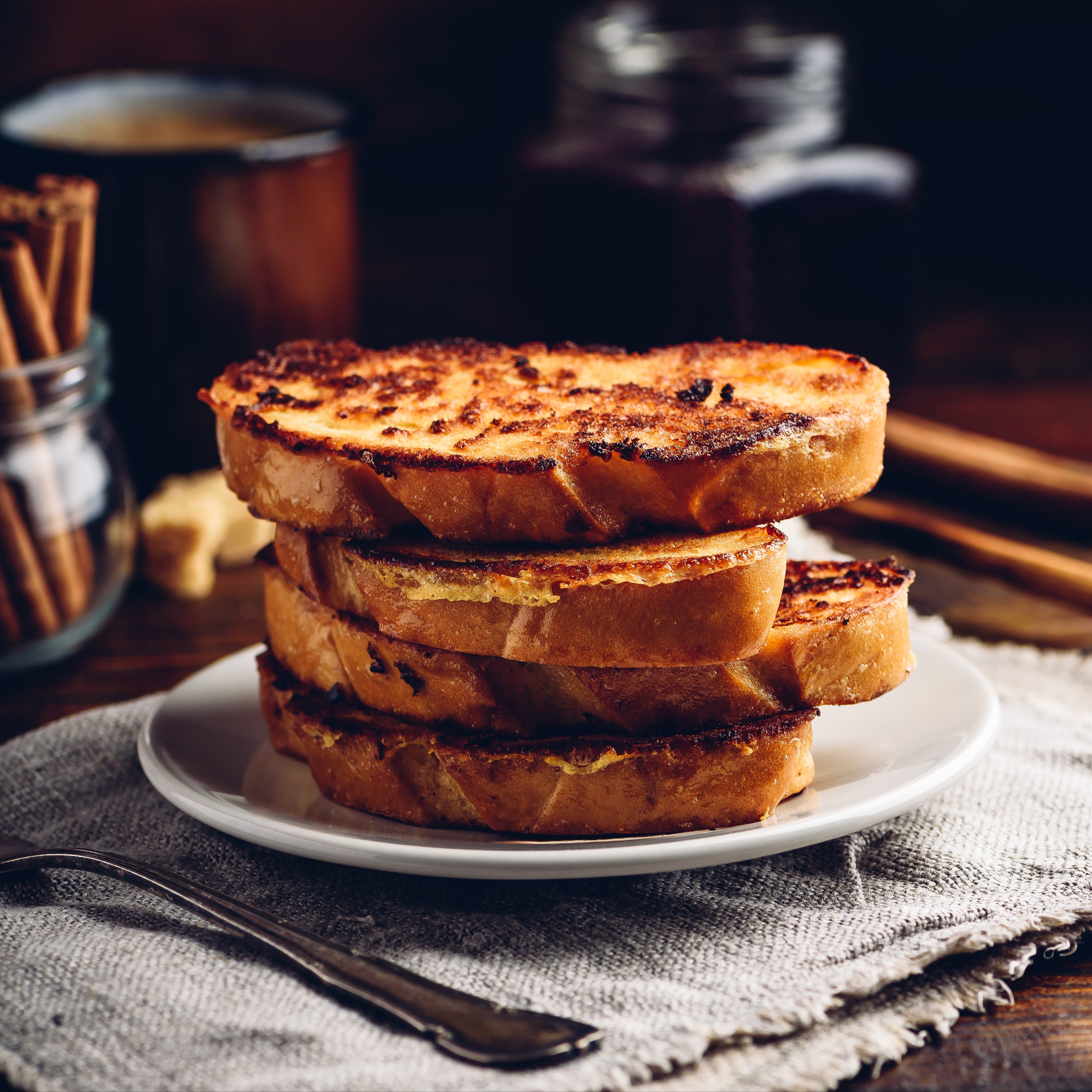 Stack of French toast scented with Pumpkin Spice on a dark background.