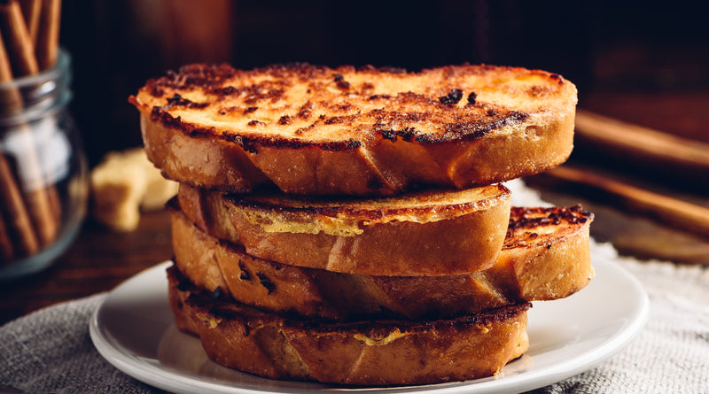 Stack of French toast scented with Pumpkin Spice on a dark background.