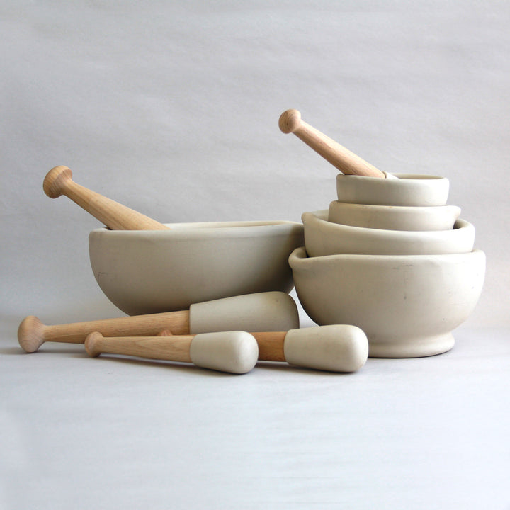 Family of different-sized ceramic mortar and pestles.