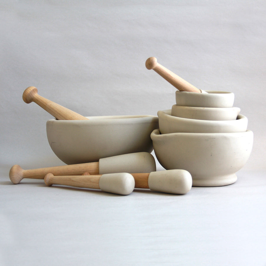 Family of different-sized ceramic mortar and pestles.