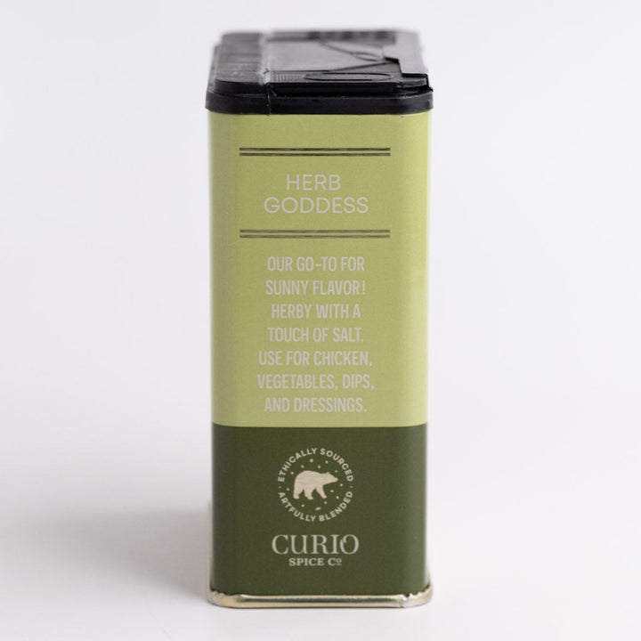 Green spice container labeled 'Herb Goddess' by Curio Spices Co on a white background