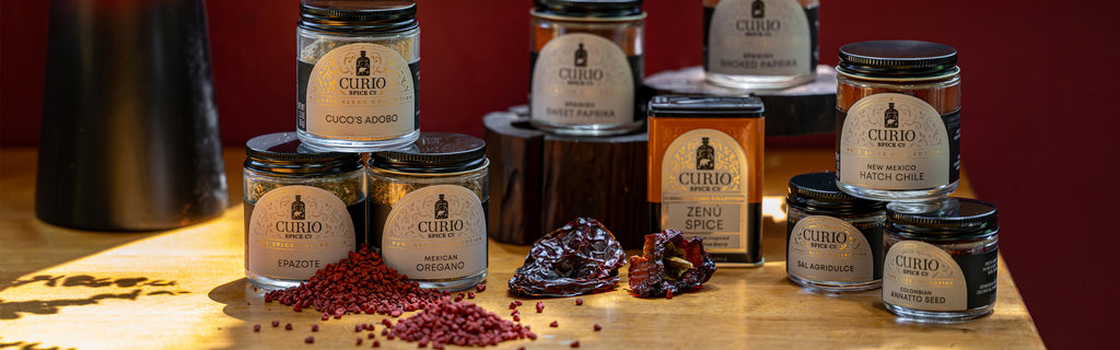 Jars of Spice products on a wooden surface with a dark background