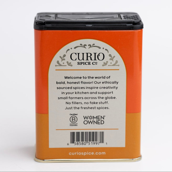 Curio Spice Co. spice container with a white label on an orange background