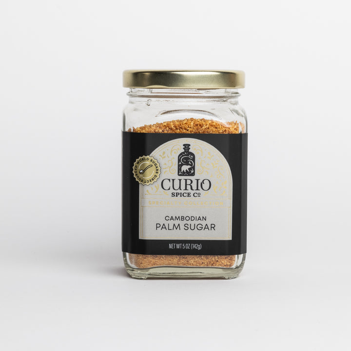 Jar of Cambodian palm sugar with 'Curio Spice Co.' label on a white background