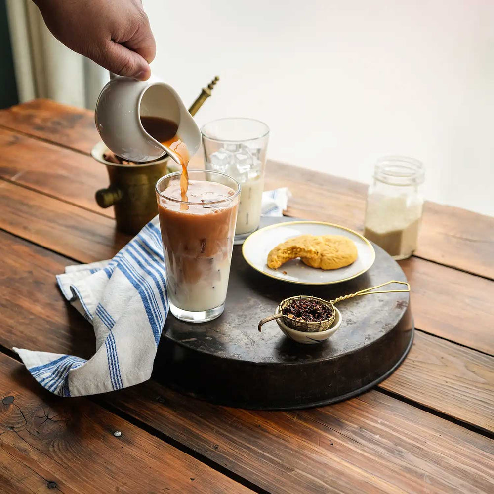 Image of Honeybush Chai concentrate being poured into milk.