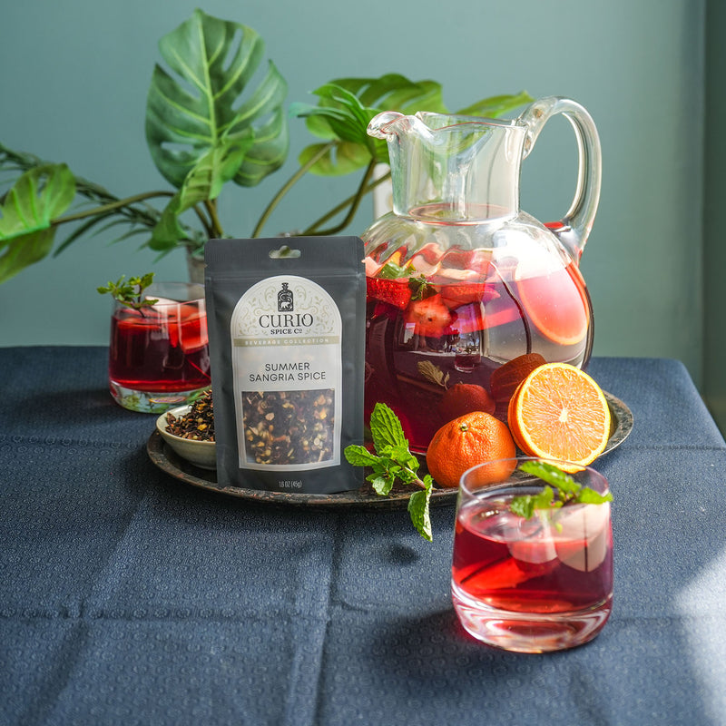 Bag of Summer Sangria Spice next to a pitcher of fruited Sangria.