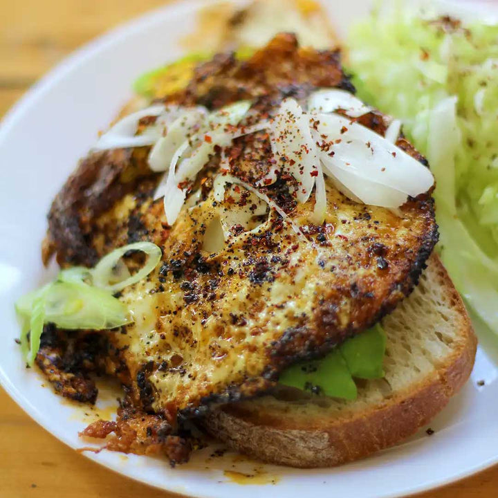 Korean BBQ spice rub sprinkled over a fried egg on avocado toast