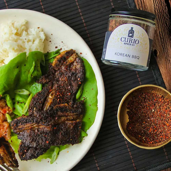 Korean BBQ short ribs with rice and lettuce next to a jar of Korean BBQ seasoning