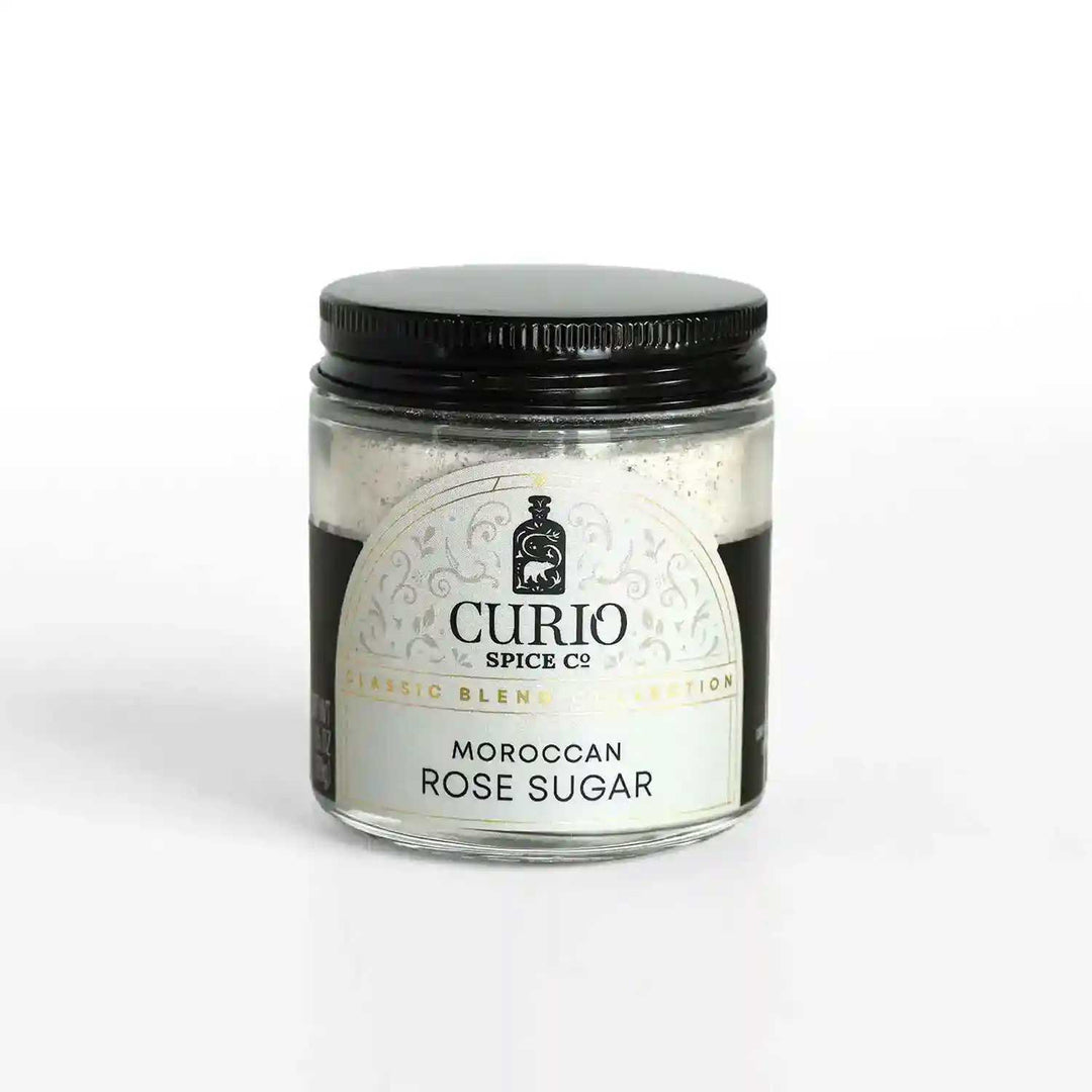 A glass jar of Moroccan Rose Sugar, a blend of fair trade cane sugar and Moroccan Damask rose petals.