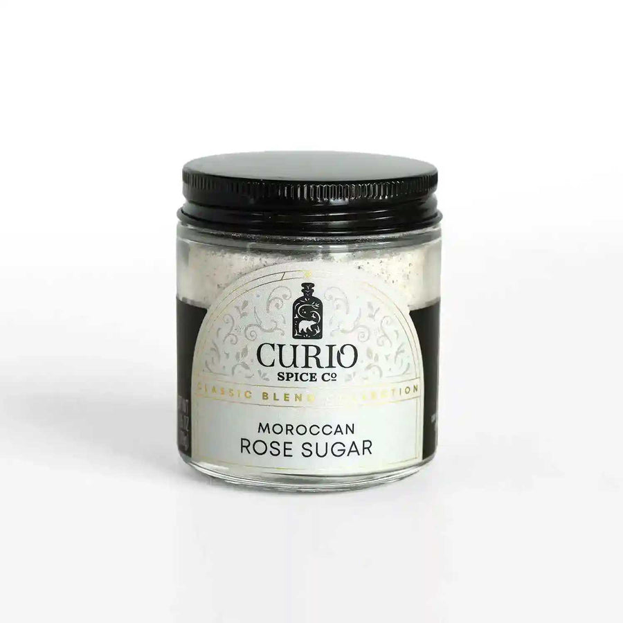 A glass jar of Moroccan Rose Sugar, a blend of fair trade cane sugar and Moroccan Damask rose petals.