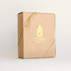 Closed gift box of the 8-Tin Chef Set with a Curio Spice logo and gold ribbon