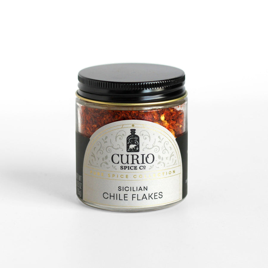 Curio Spice Co. fair-trade single origin sustainable Sicilian Chile Flakes in a glass jar.