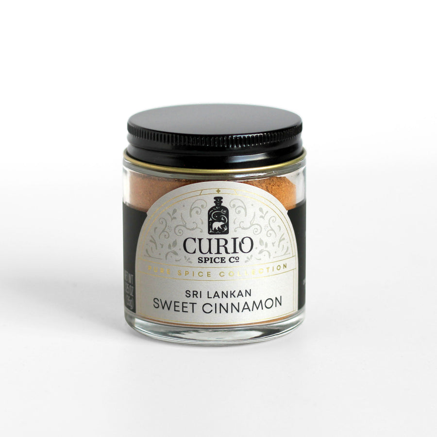 Ground Sri Lankan Sweet Cinnamon in a Curio Spice glass jar.