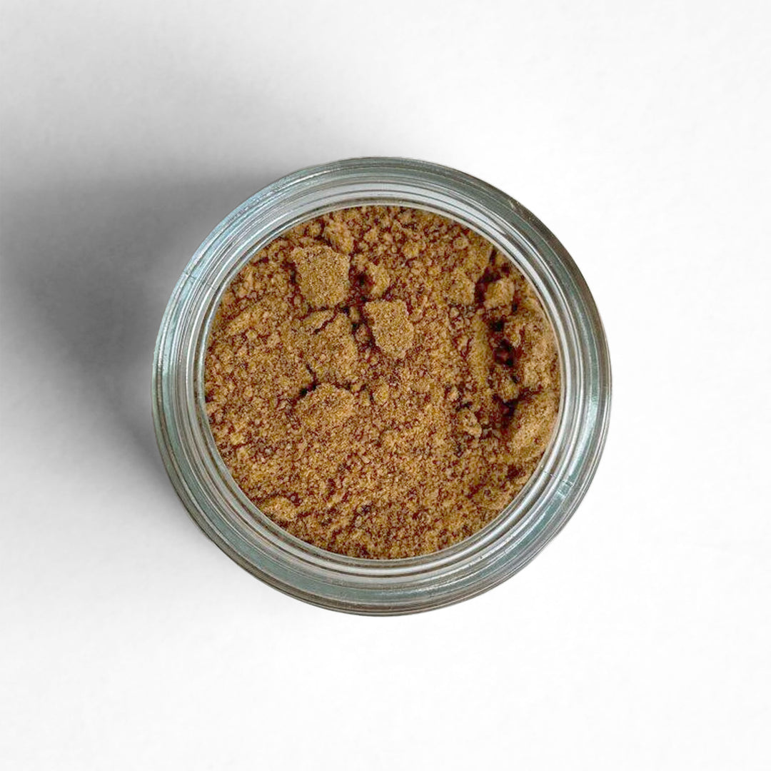 Curio Spice Co. fair-trade single origin sustainable Sri Lankan ground nutmeg in a glass jar from above.