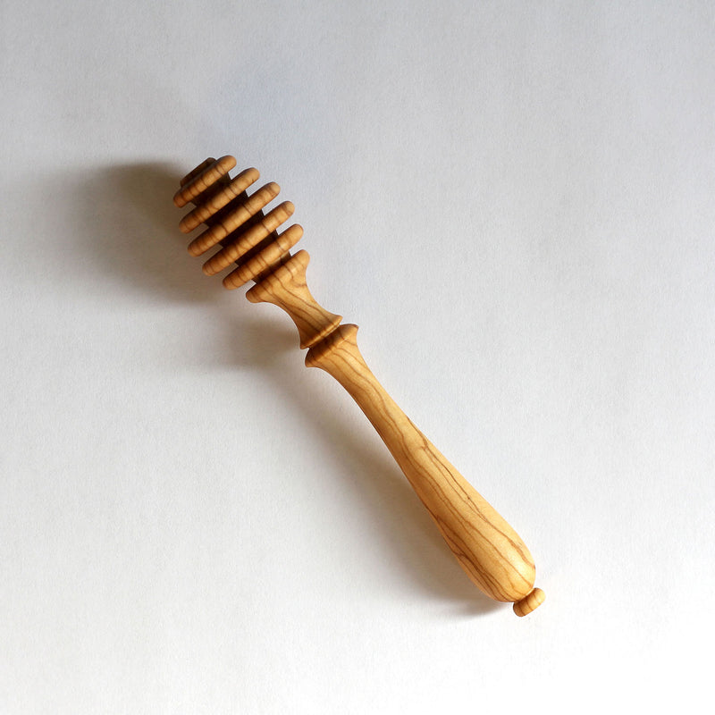 Olive Wood Honey Dipper made from a single piece of olive wood and handcrafted by Greek artisans.