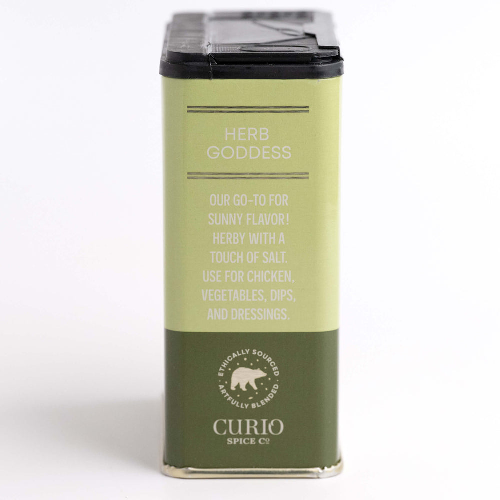 Green spice container labeled 'Herb Goddess' by Curio Spices Co on a white background