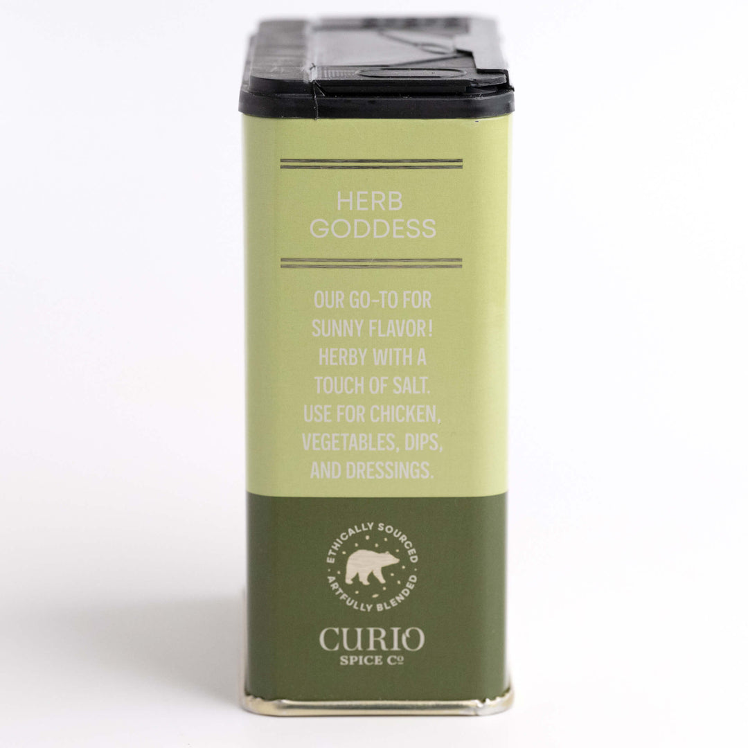 Green spice container labeled 'Herb Goddess' by Curio Spices Co on a white background