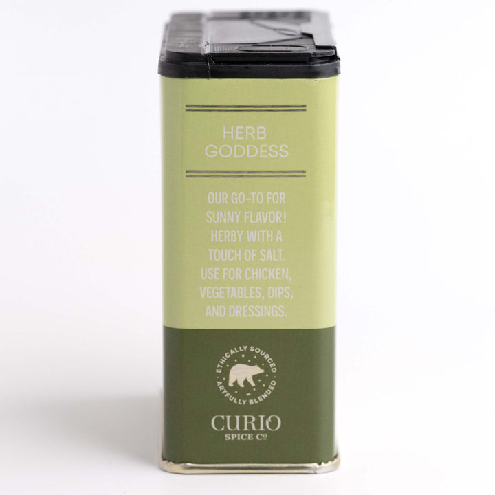 Green spice container labeled 'Herb Goddess' by Curio Spices Co on a white background