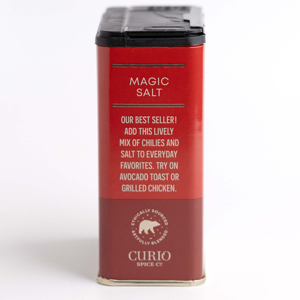 Red container of 'Magic Salt' by Curio Spice Co. on a light gray background