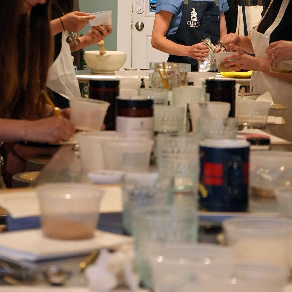 A group working on their spice blends during our corporate events classes.
