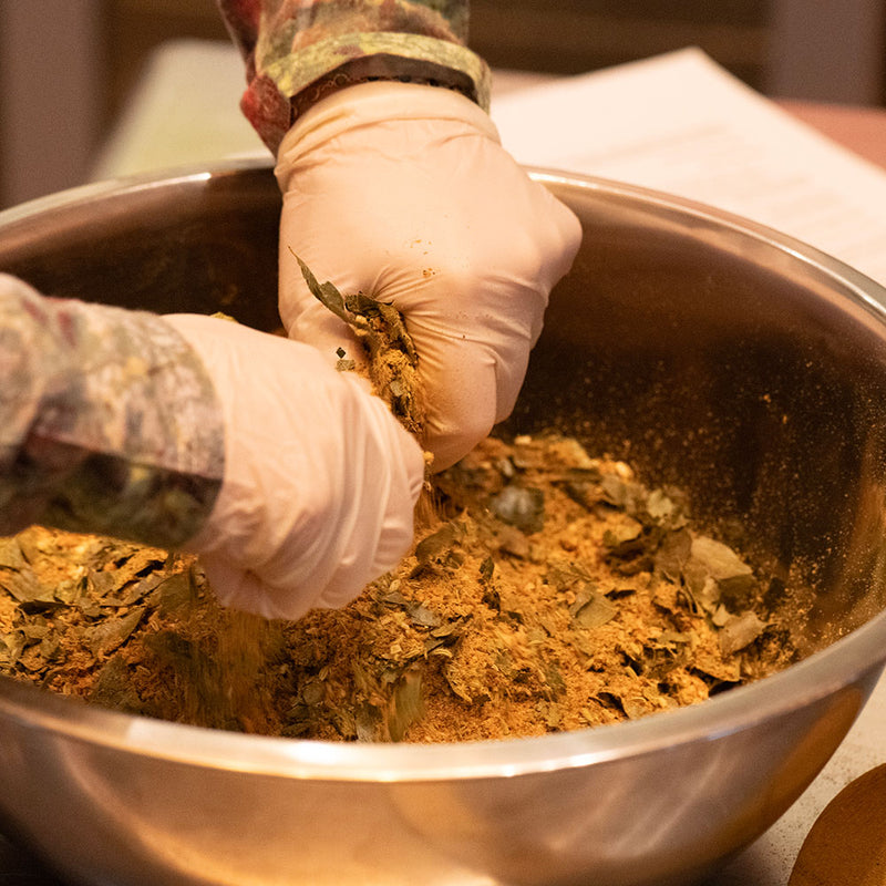 Blending spices by hand at Curio's classes in Cambridge