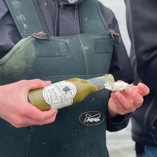 Fishermen pouring Lighthouse Keepers Jalapeno Shipwreck Hot Sauce
