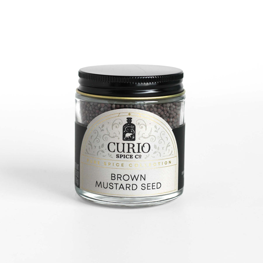 Curio Spice Co. fair-trade single origin sustainable brown mustard seed in a glass jar.