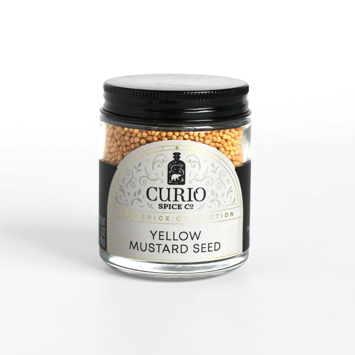 Curio Spice Co. fair-trade single origin sustainable yellow mustard seed in a glass jar.