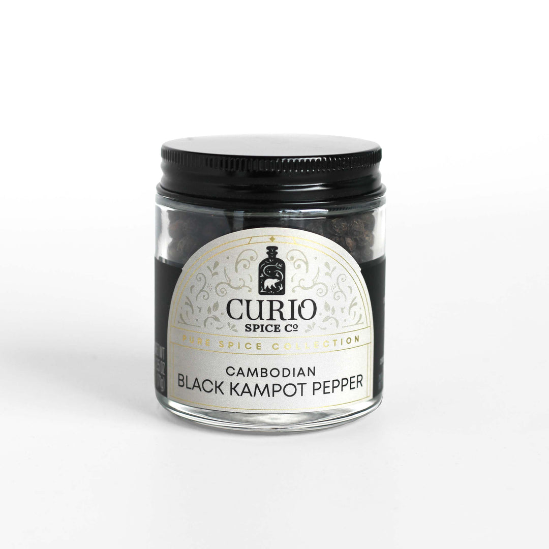 Curio Spice Co. fair-trade single origin sustainableCambodian Black Kampot Pepper in a glass jar.