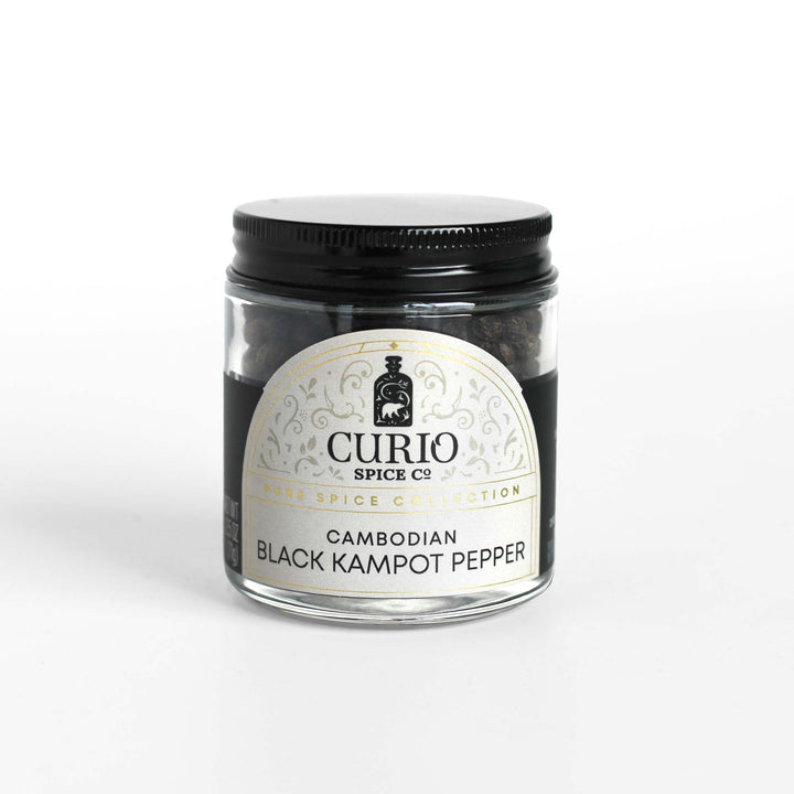 Curio Spice Co. fair-trade single origin sustainableCambodian Black Kampot Pepper in a glass jar.