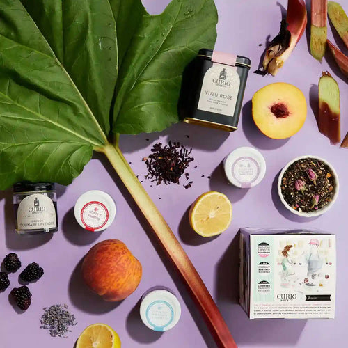 Scattered image on a purple background showing Curio Spice's Culinary Lavender and Yuzu Rose.