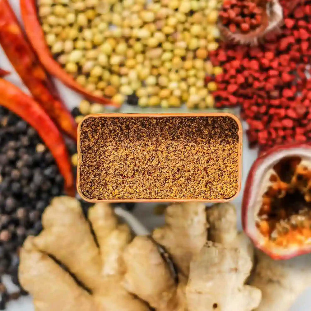 Top-down of Curio's Zenú Spice with ingredients surrounding the tin.