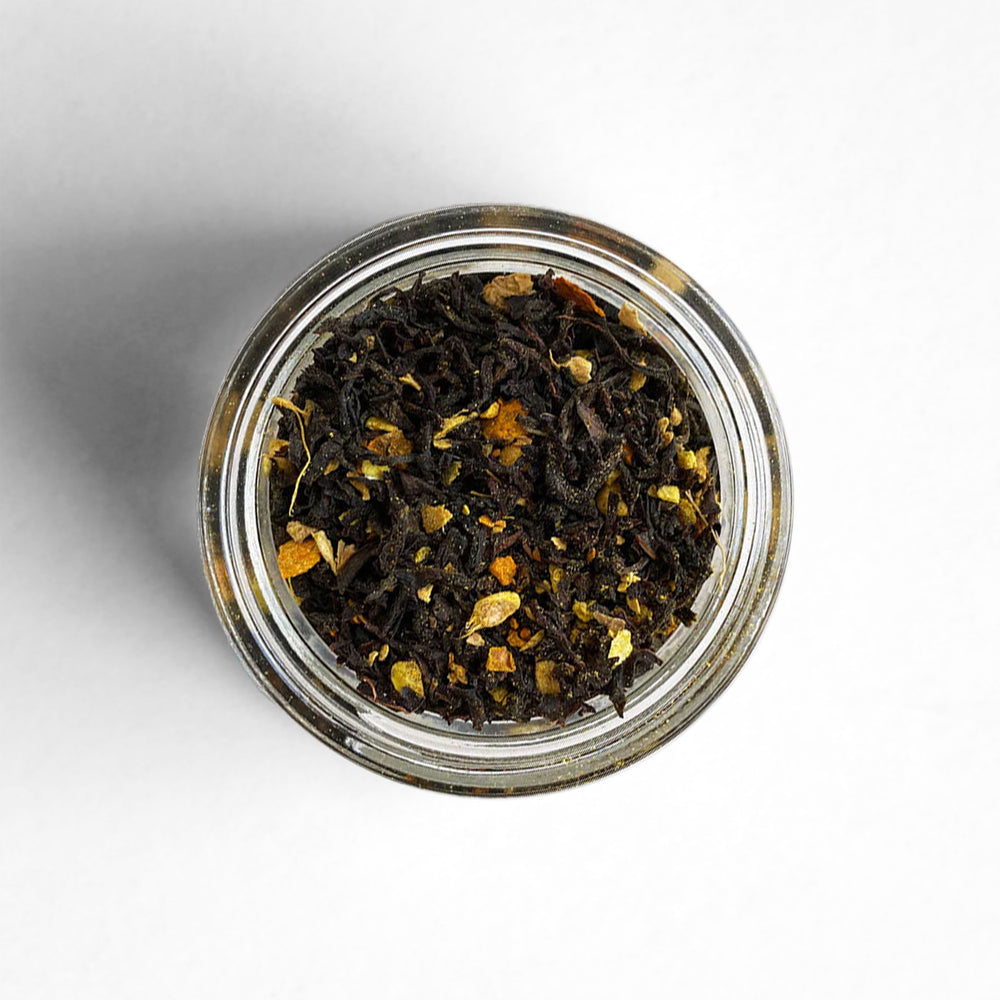 A top-down view of Sunrise black tea, a blend with makrut lime zest, ginger, and turmeric.