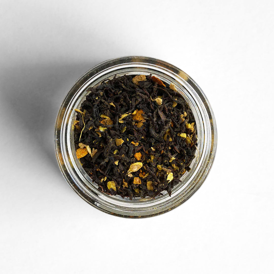 A top-down view of Sunrise black tea, a blend with makrut lime zest, ginger, and turmeric.