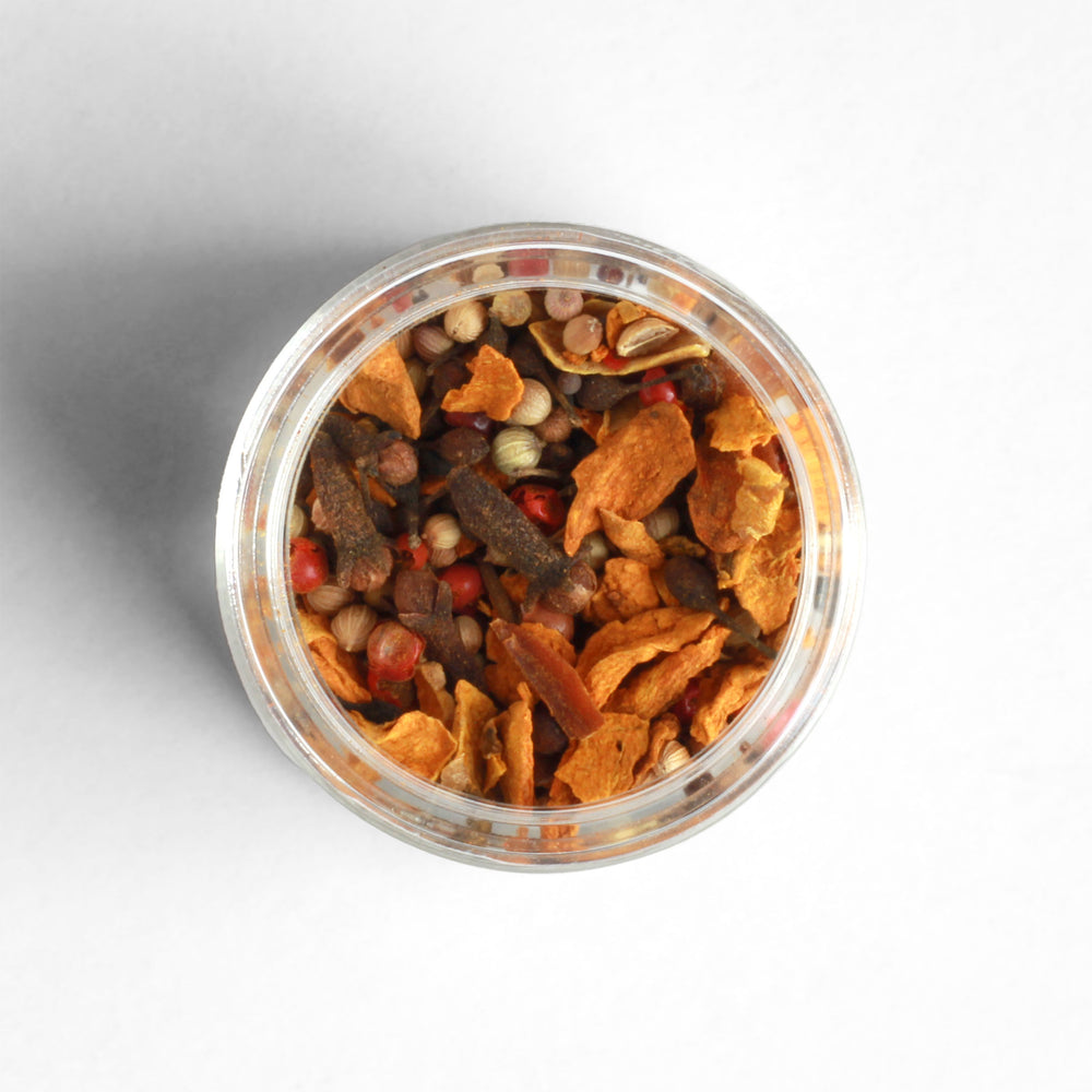 Top-down view of Madagascar Pickling Spice containing turmeric chips, coriander, voatsiperifery, and more.