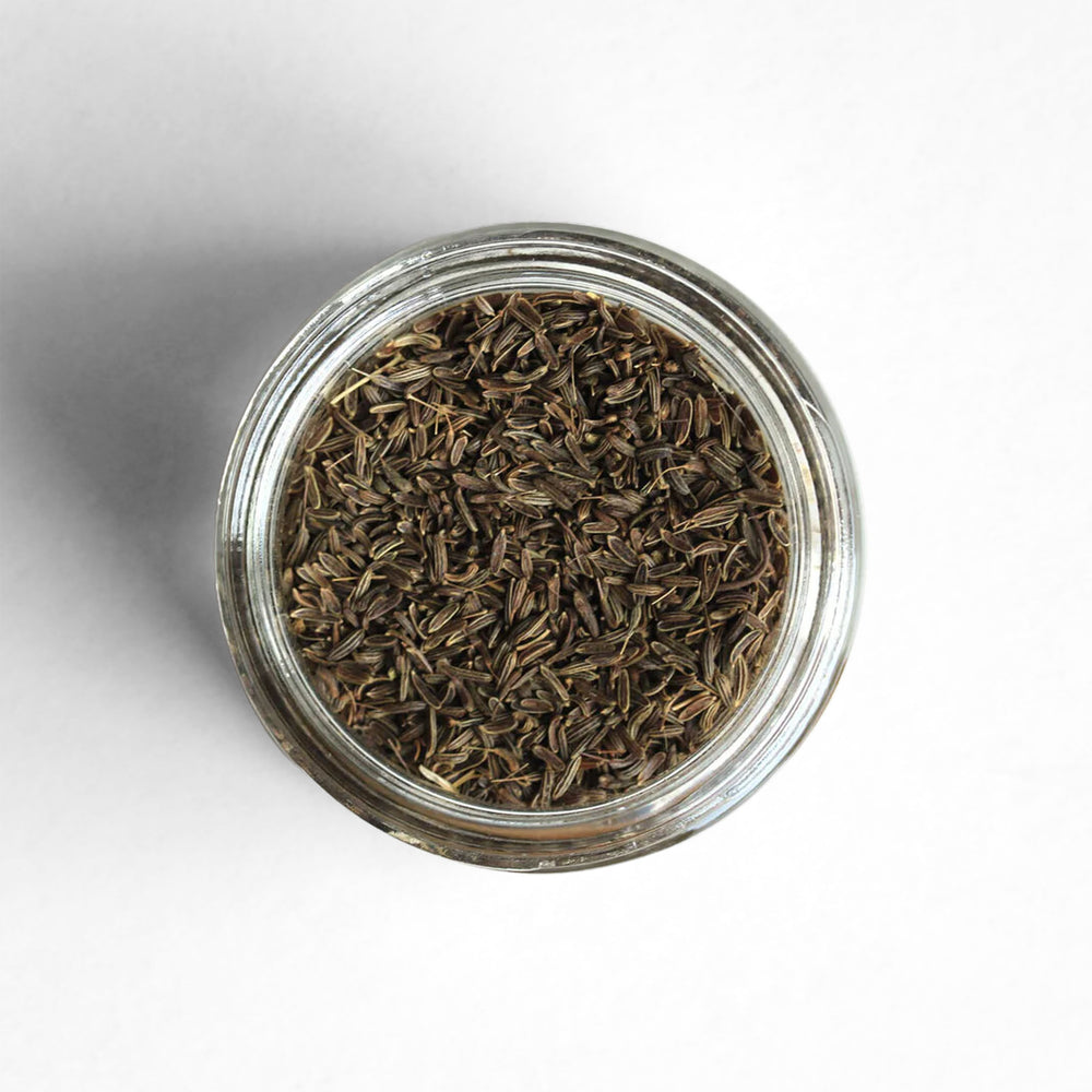 Curio Spice Co. fair-trade single origin sustainable Afghan wild cumin seed in a glass jar from above.