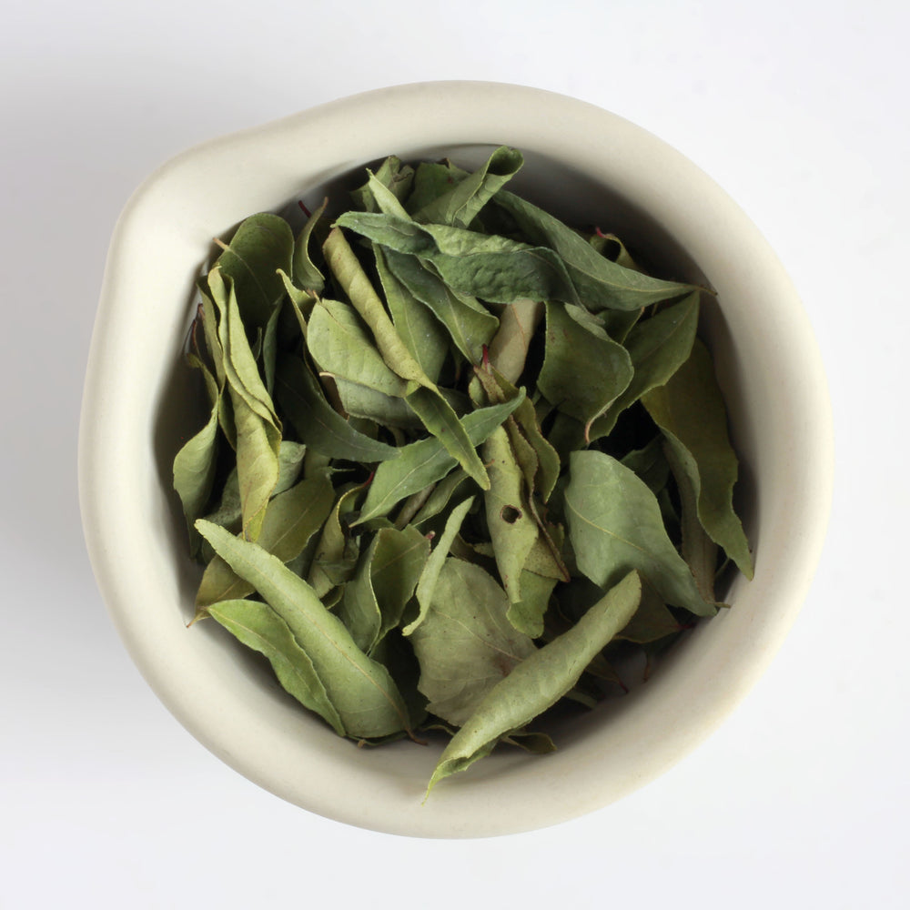 Californian curry leaves in a ceramic bowl.