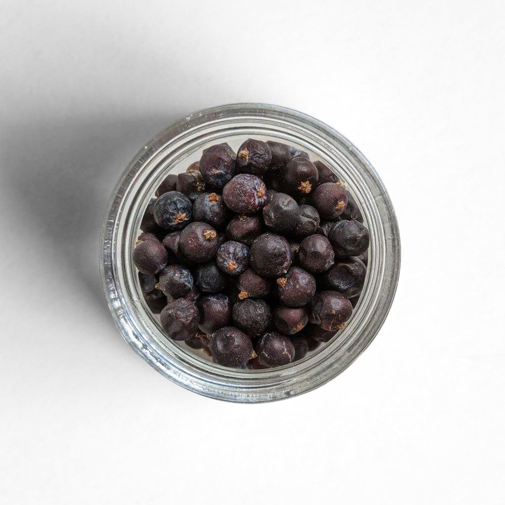 Curio Spice Co. fair-trade single origin sustainable juniper berries in a glass jar from above.