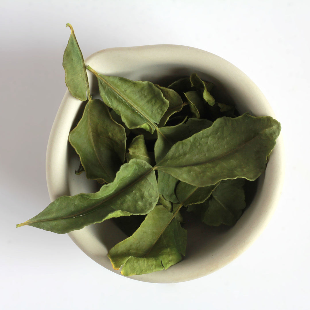 Makrut Lime Leaves in a white ceramic bowl