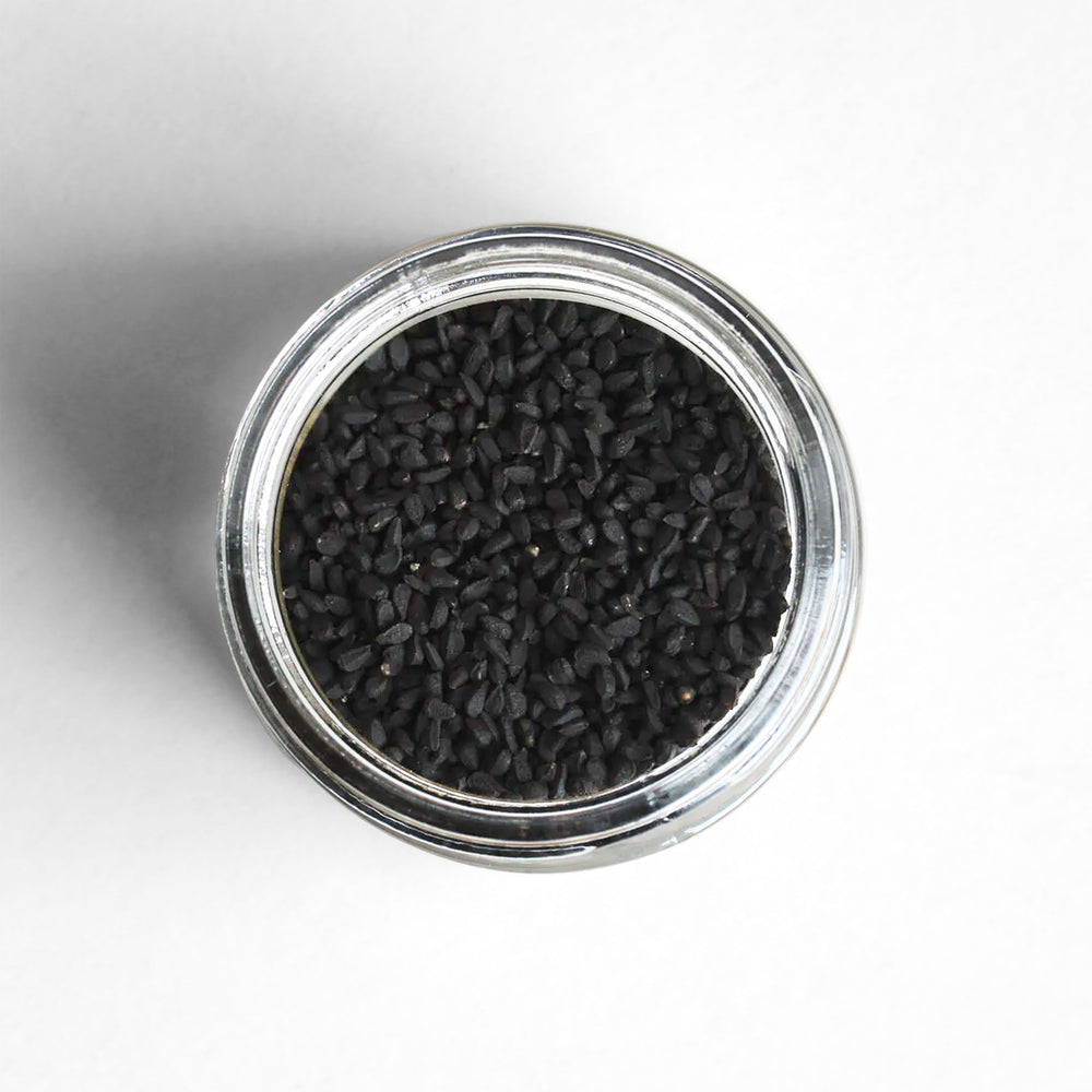 Curio Spice Co. fair-trade single origin sustainable nigella seed in a glass jar from above.