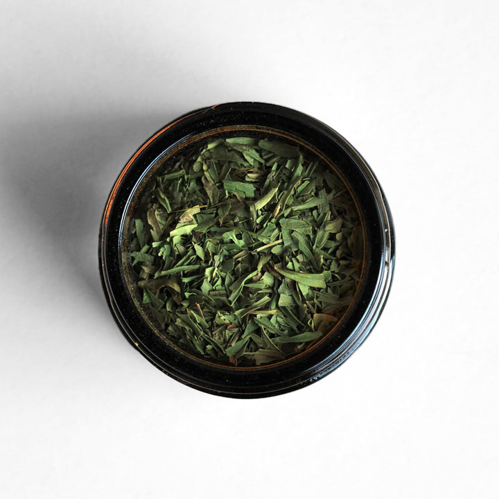 Top-down view of tarragon featuring its distinct bright green color.